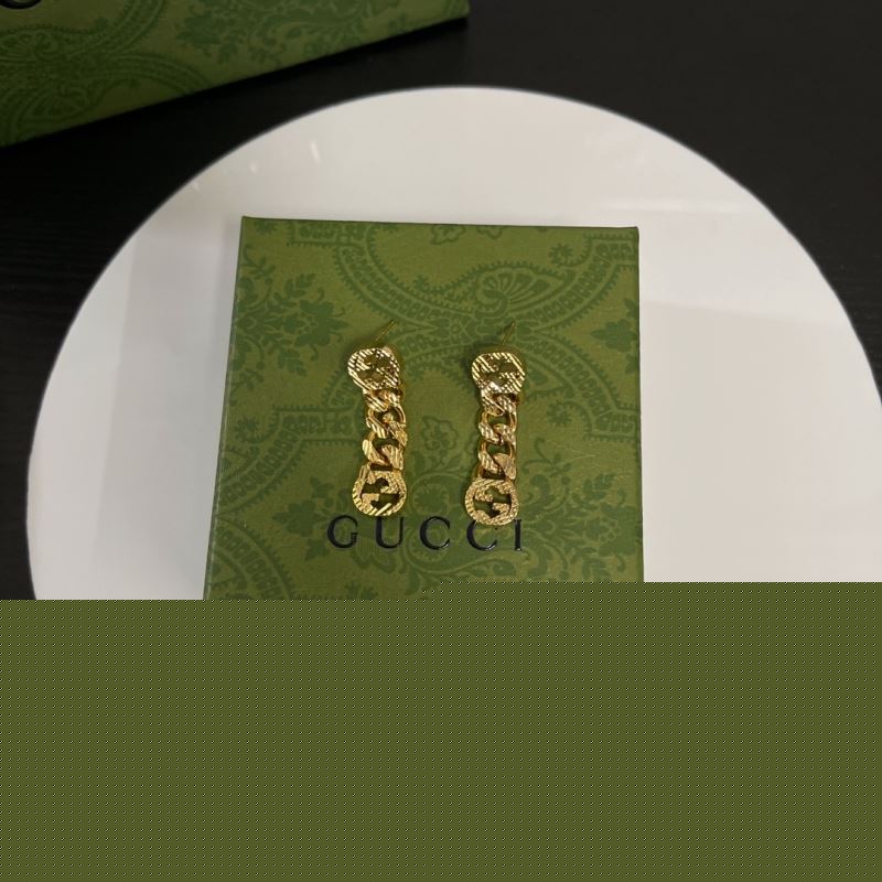 G*u*i earrings